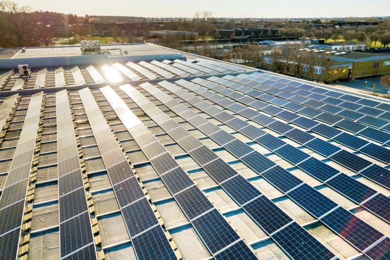 Top view of blue shiny solar photo voltaic panels system produci Top view of blue shiny solar photo voltaic panels system producing renewable clean energy abstract background.